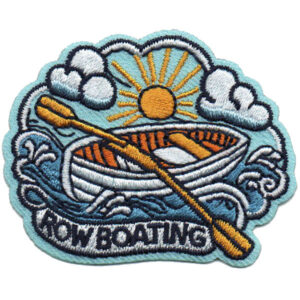 The Row Boating Patch (Copy) is an embroidered patch showing a rowboat on waves, a yellow oar, sun and clouds above, with “ROWBOATING” at the bottom.