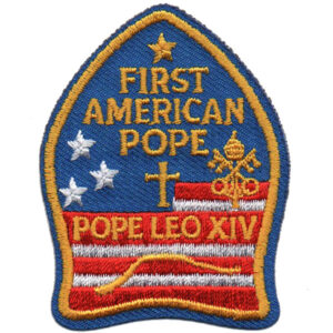 The First American Pope Patch (stripes) is blue and shaped like a bishop's miter with gold trim, reading "FIRST AMERICAN POPE" above "POPE LEO XIV," and features stars, a cross, papal insignia, stripes, and a gold car outline.