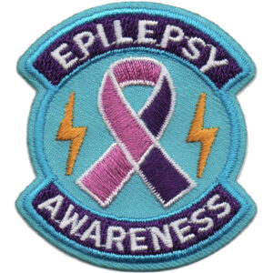The Epilepsy Awareness Patch features a circular blue background, a purple and pink ribbon, two yellow lightning bolts, and “Epilepsy Awareness” embroidered on it.