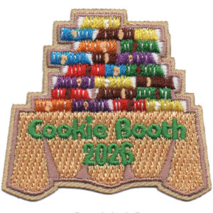 The 2026 Cookie Booth Patch (Copy) features an embroidered design of stacked cookie boxes on a table with "Cookie Booth 2026" in green lettering across the front.