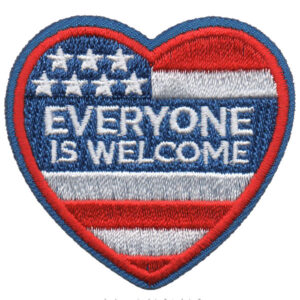 The Everyone Is Welcome patch features a heart-shaped American flag design with "EVERYONE IS WELCOME" stitched in white across the center.
