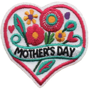 The Mother's Day Patch (Copy) is a heart-shaped embroidered patch with colorful flowers and leaves, featuring "MOTHER'S DAY" in bold black letters across the center.