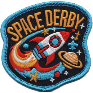 The Space Derby Patch is an embroidered patch with "SPACE DERBY" text, featuring a red and white rocket, stars, a ringed planet, crescent moon, and blue fleur-de-lis on a dark background with a light blue border.