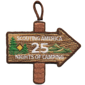 The 25 Nights of Camping Scout patch is shaped like a wooden sign with an arrow, embroidered with "Scouting America 25 Nights of Camping," two green trees, a yellow diamond, and a green mountain.