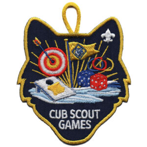 The Cub Scout Games (Copy) patch is wolf-shaped and embroidered with a target and arrows, bean bag toss board, dice, rings, flag, fleur-de-lis, and "CUB SCOUT GAMES" text at the bottom.