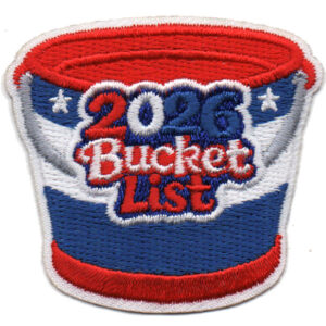 The 2025 Bucket List Patch (Copy) is an embroidered patch shaped like a bucket in red, white, and blue with stars and "2025 Bucket List" stitched boldly on the front.