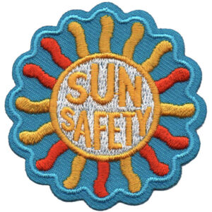 The Lake Fun Patch (Copy) is a vibrant embroidered patch with a blue scalloped edge, yellow and orange sun rays, and bold yellow "SUN SAFETY" text in the center.