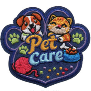 The Pet Care Patch (Copy) is an embroidered patch shaped like a paw print, with a dog and cat above “Pet Care,” plus a blue food bowl, green paw prints, red yarn ball, and yellow dots.
