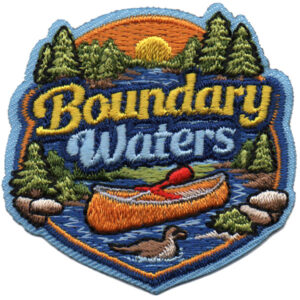 The Canoeing Patch (Copy) features "Boundary Waters" text, a canoe on a river, pine trees, rocks, a sunset backdrop, and a swimming loon in the design.
