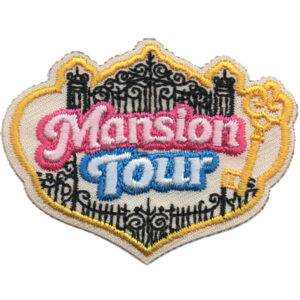The Historic Mansion Tour Patch (Copy) features ornate black gates, a yellow key, and "Mansion Tour"—with "Mansion" in pink and "Tour" in blue—on a white background trimmed with a yellow border.