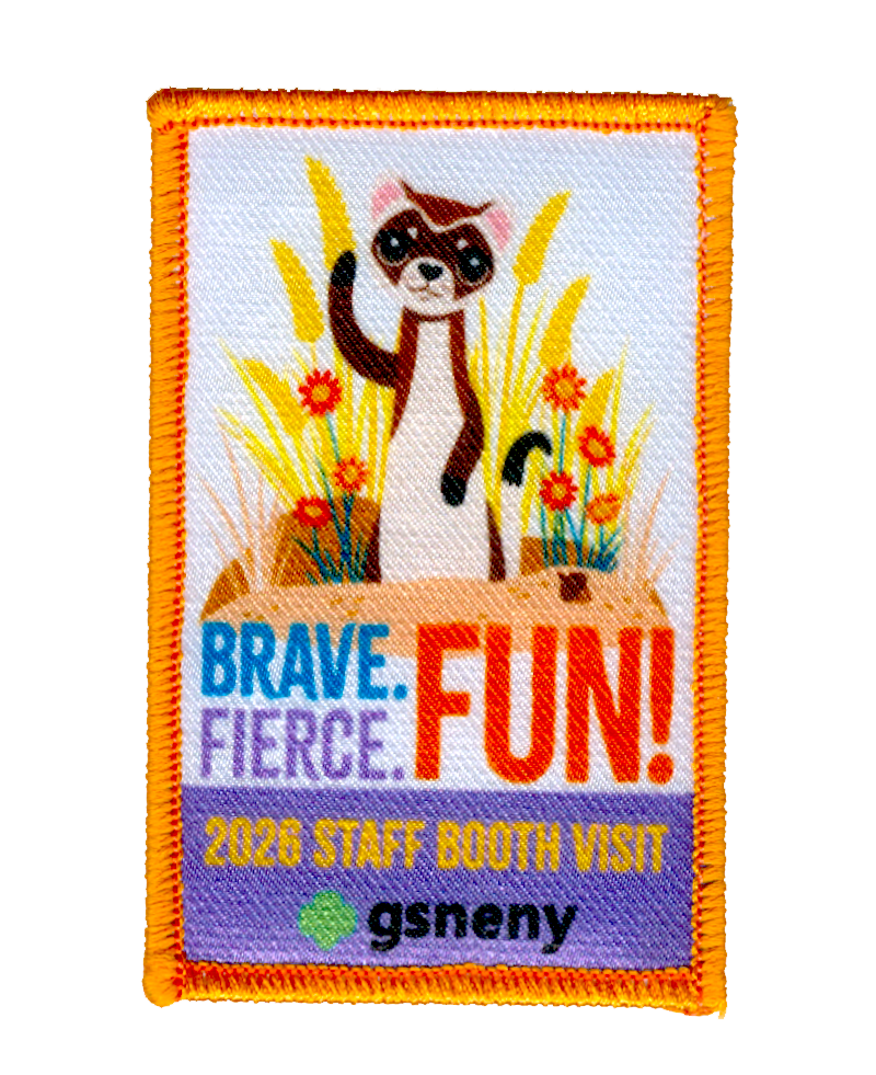 Embroidered patch with a cartoon ferret waving among flowers and grass. Text reads "BRAVE. FIERCE. FUN! 2023 STAFF BOOTH VISIT," and "gsneny" with a green trefoil logo. Patch border is orange.
