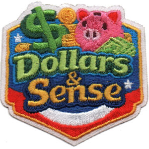 The Dollars and Sense Patch (Copy) features a green dollar sign, gold coins, pink piggy bank, and cash with "Dollars & Sense" in bold green and yellow letters on a colorful shield background.