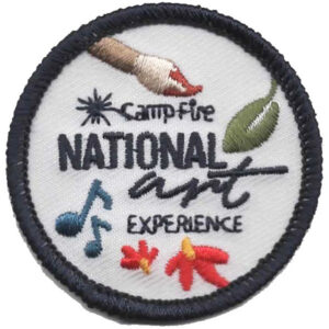 The Adventure Patch (Copy) is a round embroidered patch with “Camp Fire National Art Experience,” showing a hand, leaf, two music notes, and two flowers on a white background with a dark border.