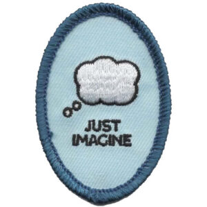 The Fire & Ice Patch (Copy) is an oval fabric patch with a blue border, showcasing a white thought bubble above "JUST IMAGINE" in black text on a light blue background.